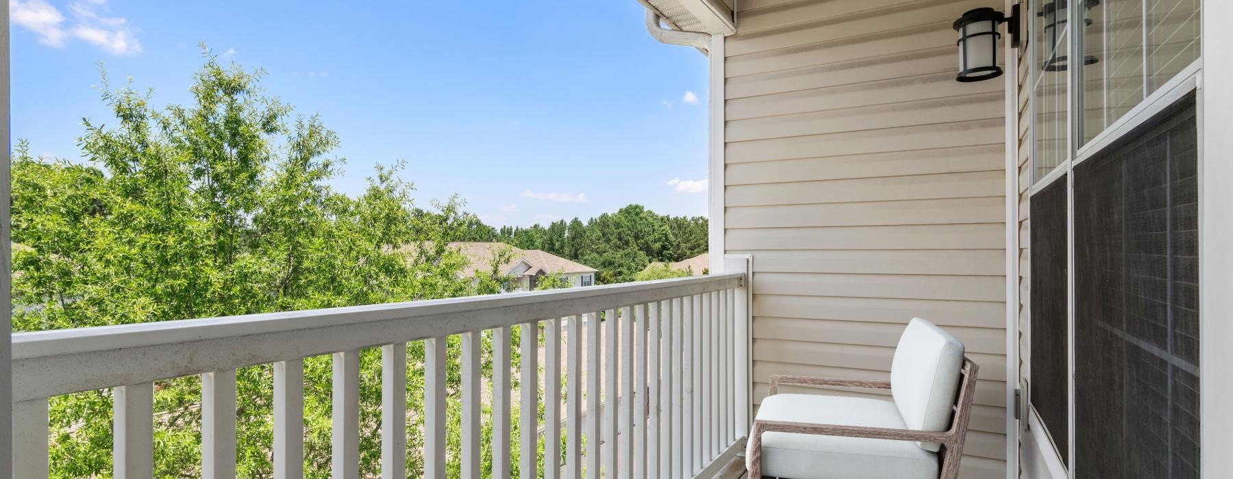 a balcony with a chair and a plant on it