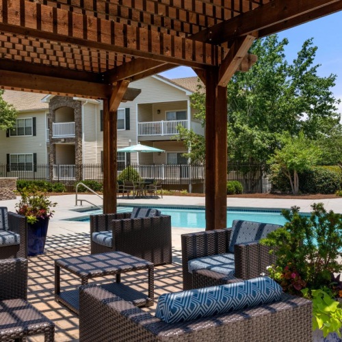 Resort-style swimming pool a patio with chairs and a pool